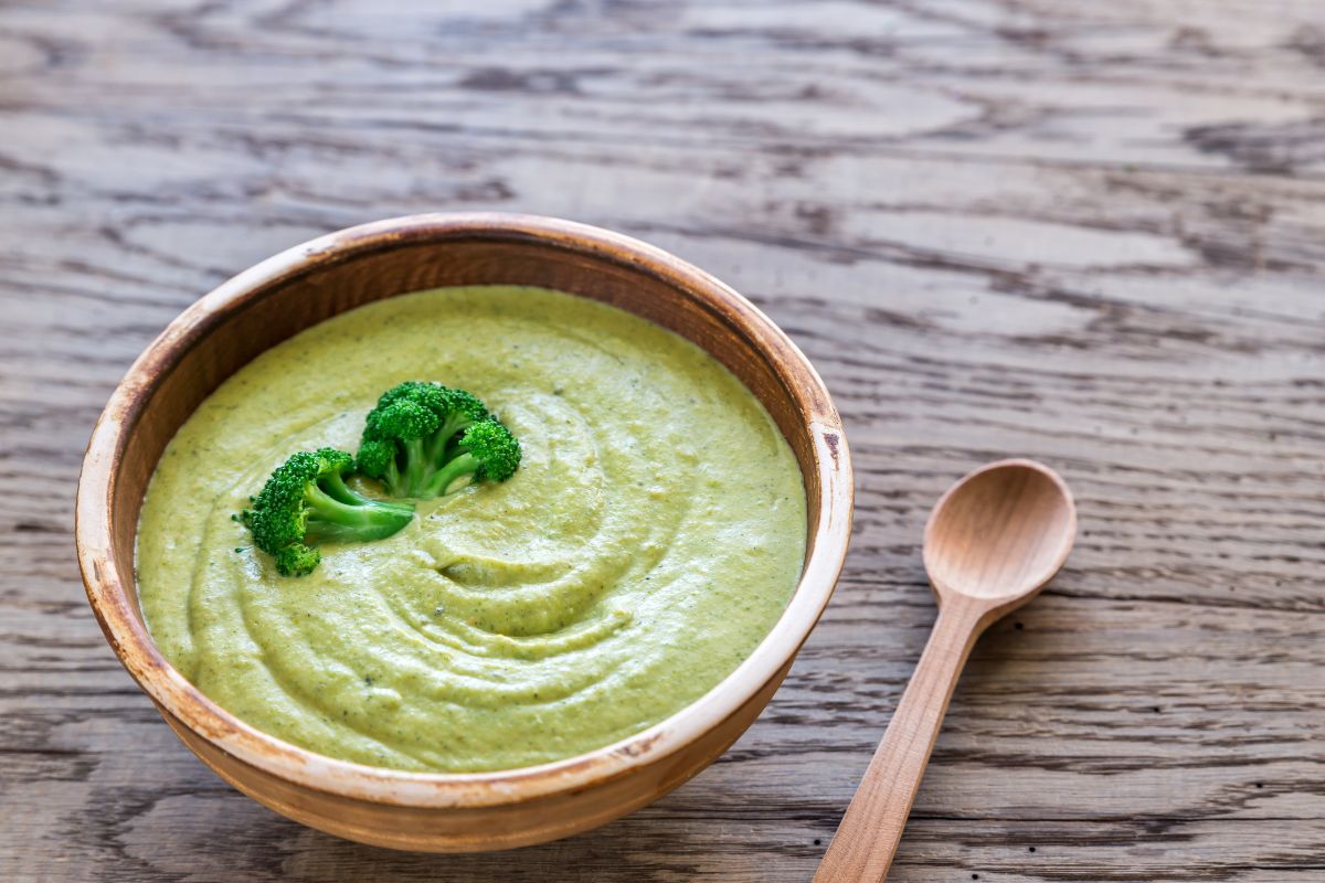 Homemade croutons, shredded cheese, and fresh herbs as garnishes for broccoli cheddar soup