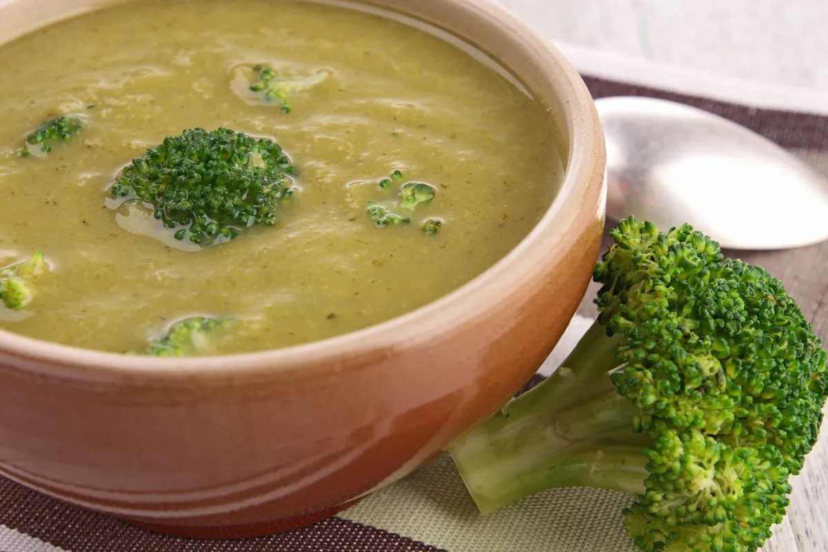 Freshly grated cheese and broccoli florets, key ingredients for gluten-free broccoli  soup
