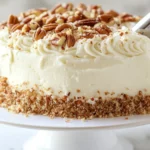 Classic Italian Cream Cake: A three-layer cake with cream cheese frosting, decorated with pecans and coconut flakes