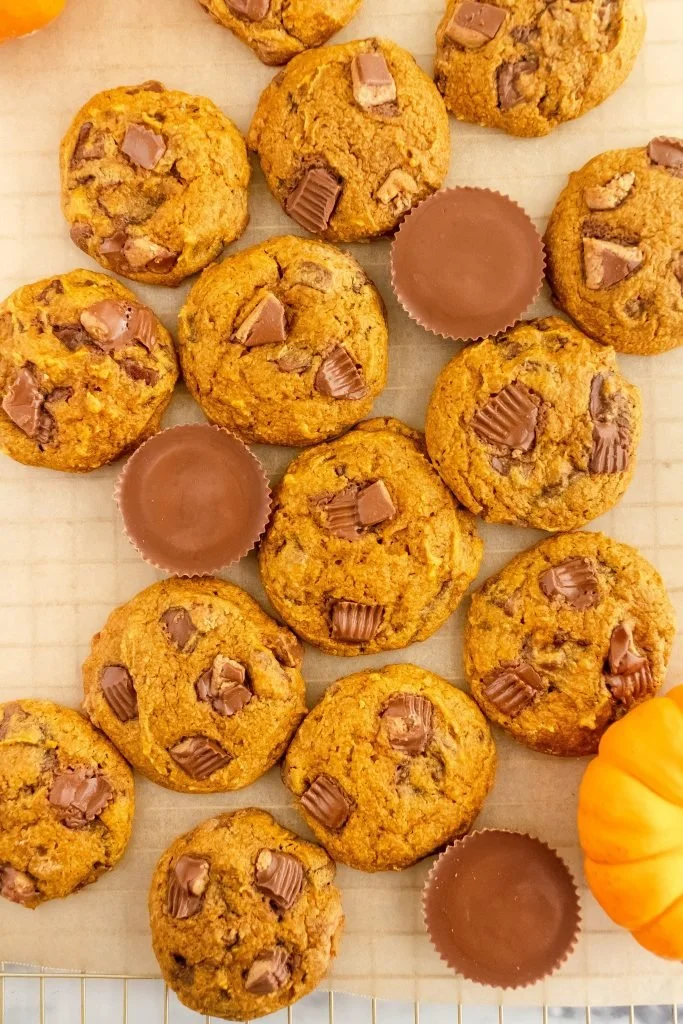 Pumpkin Peanut Butter Cup Cookies on a plate, decorated with autumn leaves